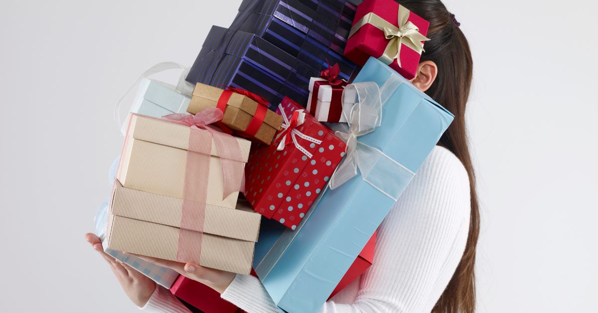 woman with too many Christmas presents