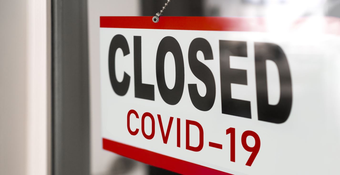 Sign on a door saying "Closed - COVID-19.